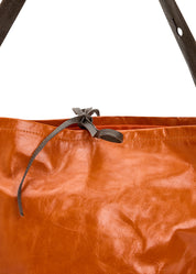 Leather bucket bag with orange button strap
