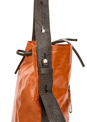 Leather bucket bag with orange button strap