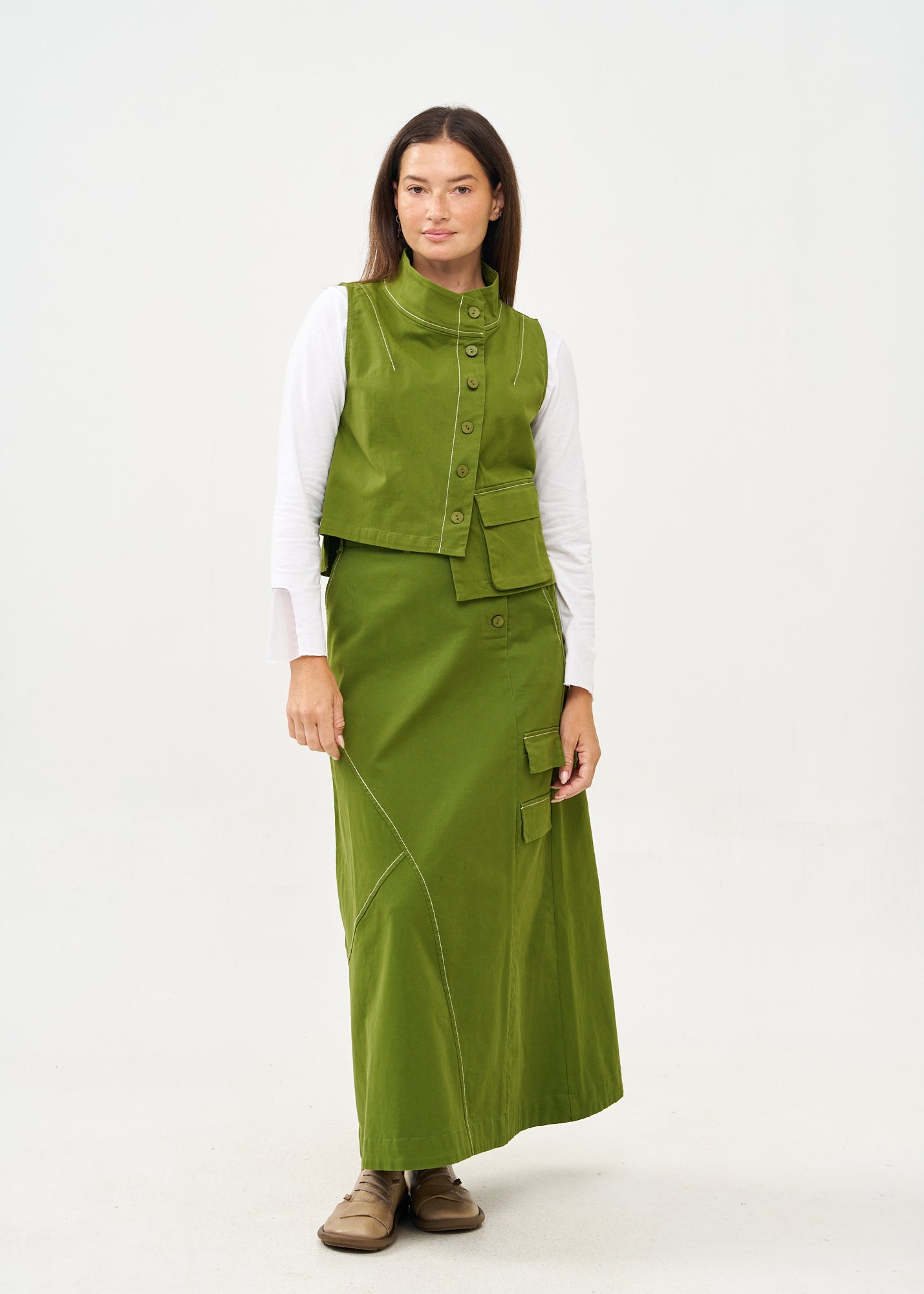 Green asymmetrical vest with prominent stitching