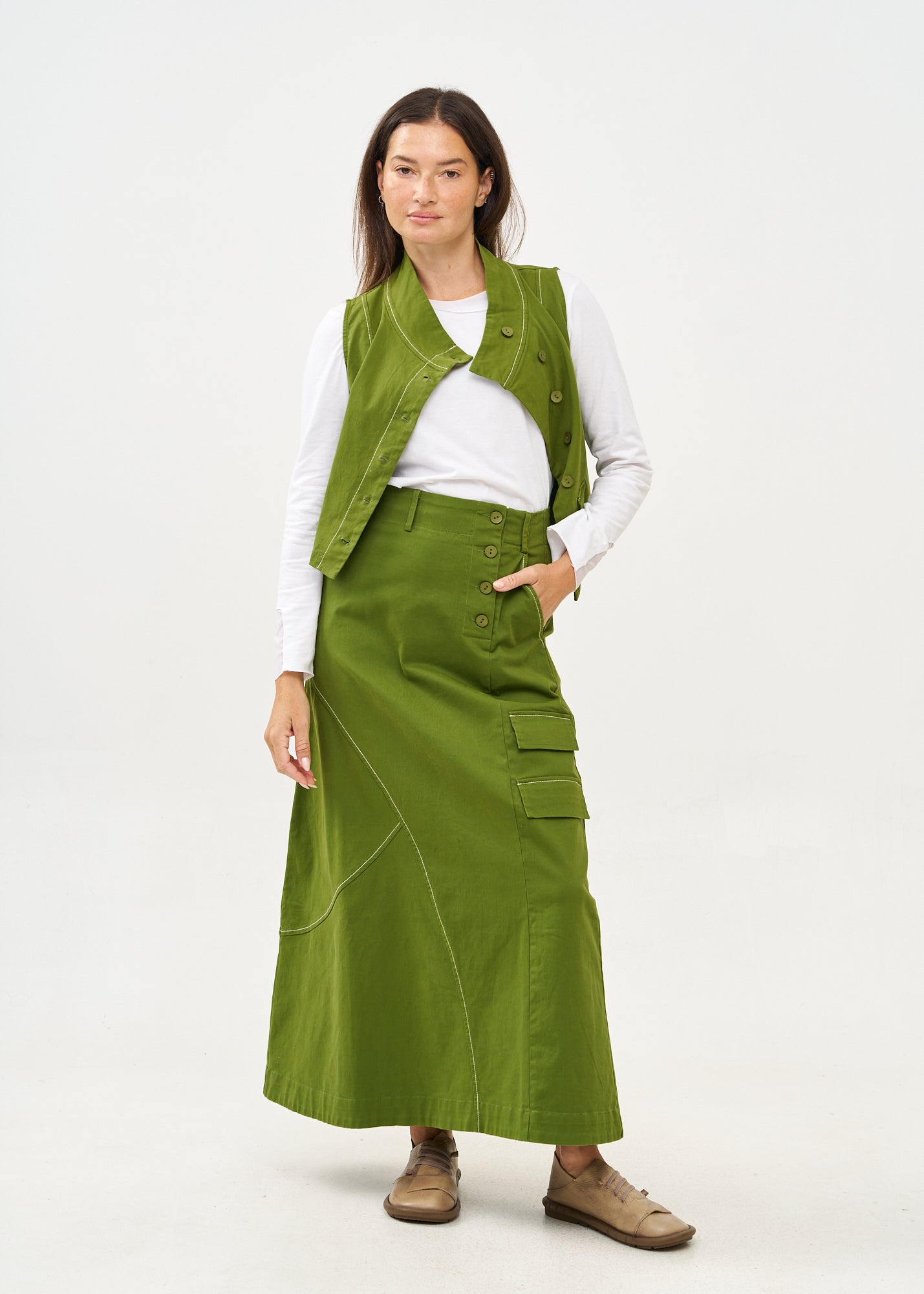Green asymmetrical vest with prominent stitching