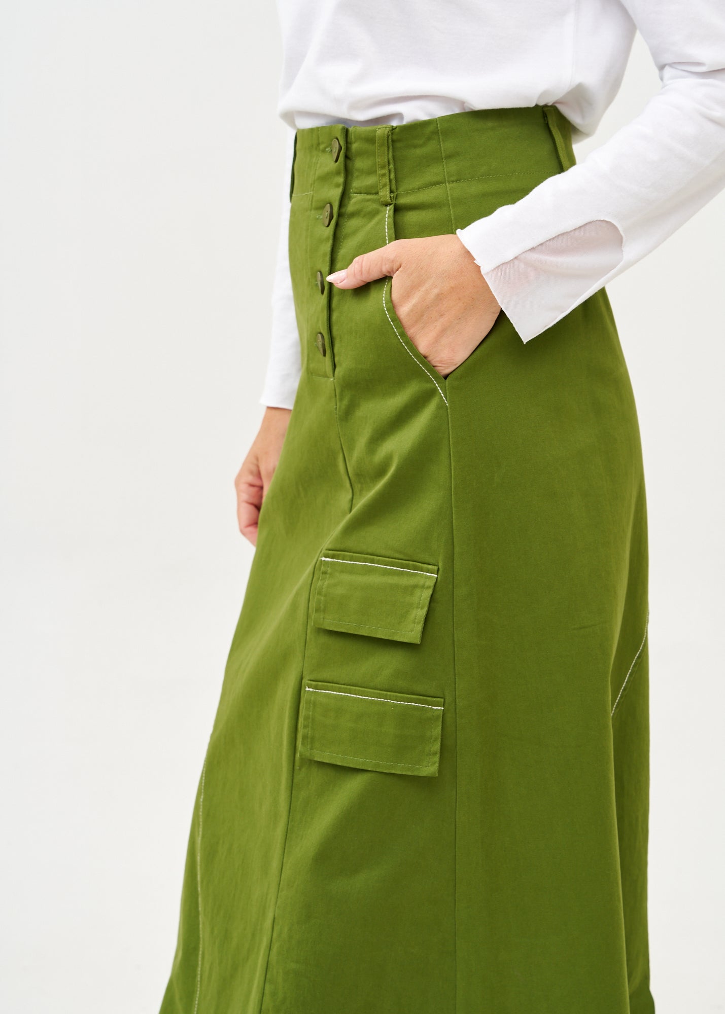 Asymmetrical cut skirt with prominent stitching in green