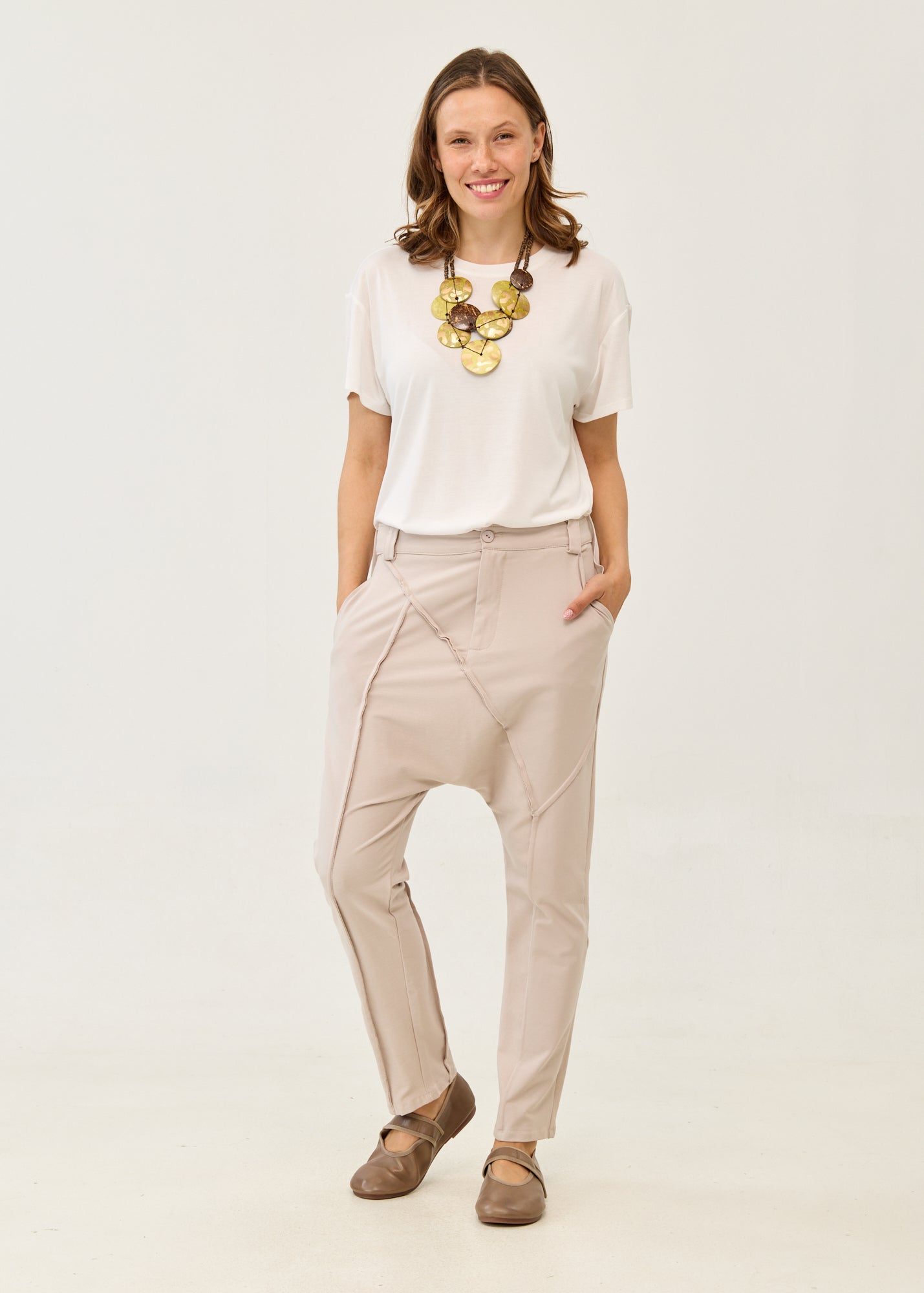 Pants with button and zipper cutouts, Stone