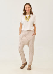 Pants with button and zipper cutouts, Stone