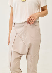 Pants with button and zipper cutouts, Stone