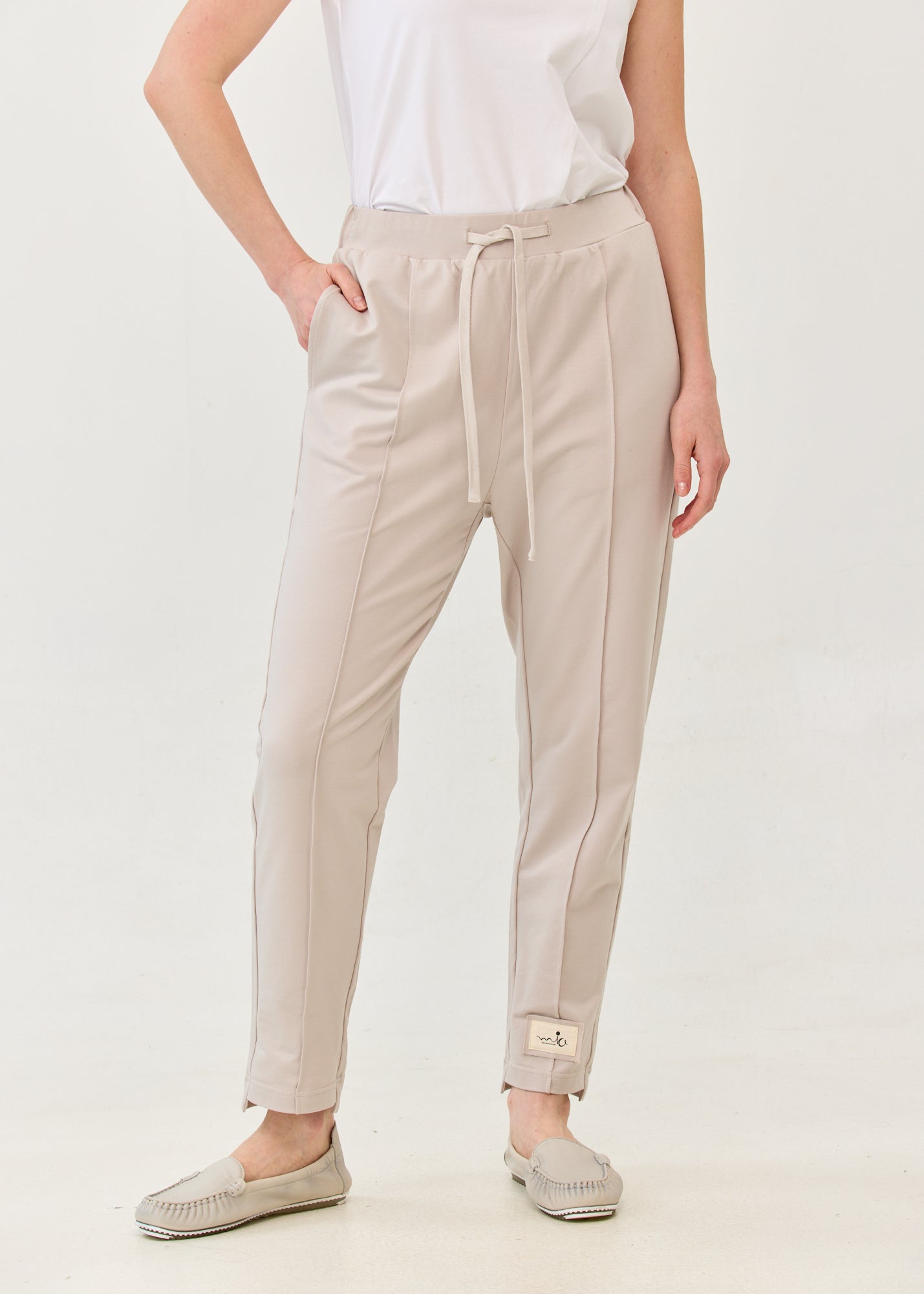 Pants with a seam in the middle and a stone patch