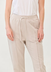 Pants with a seam in the middle and a stone patch