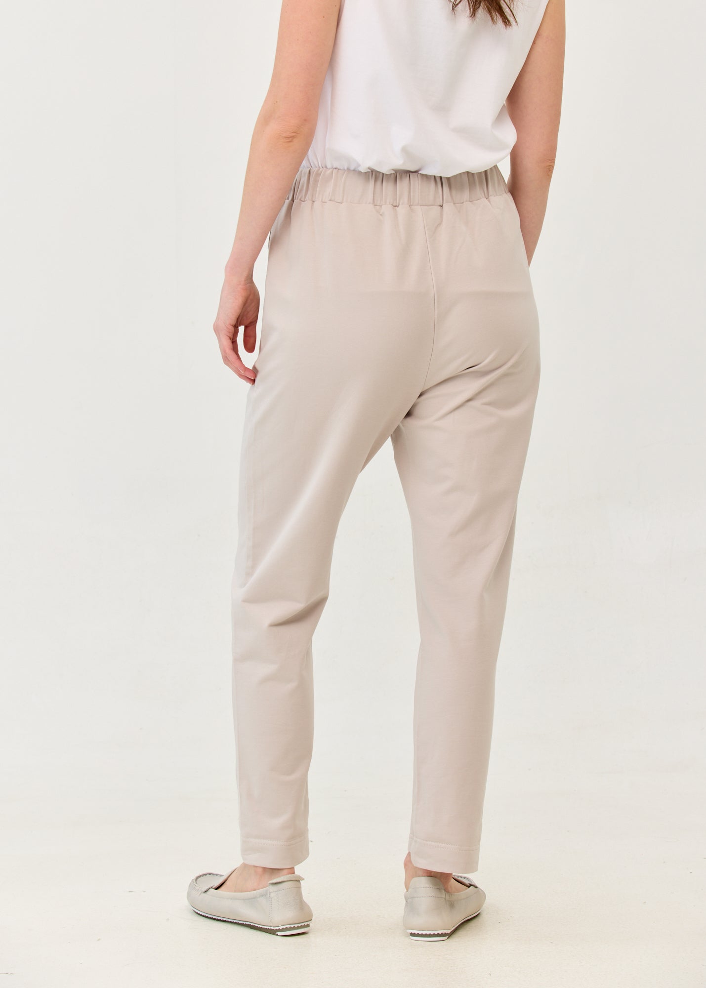 Pants with a seam in the middle and a stone patch