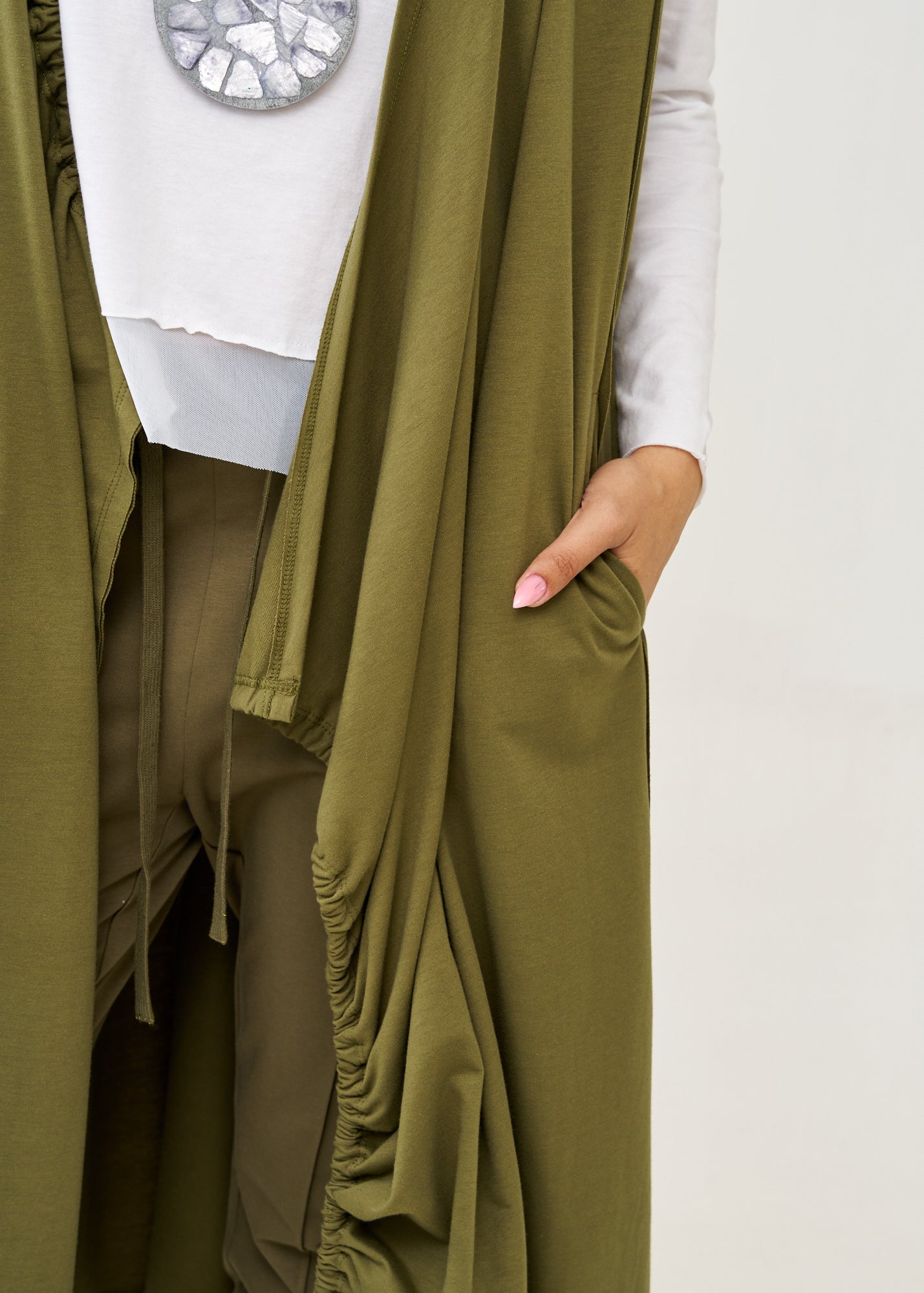 Long sleeveless top with green drawstring