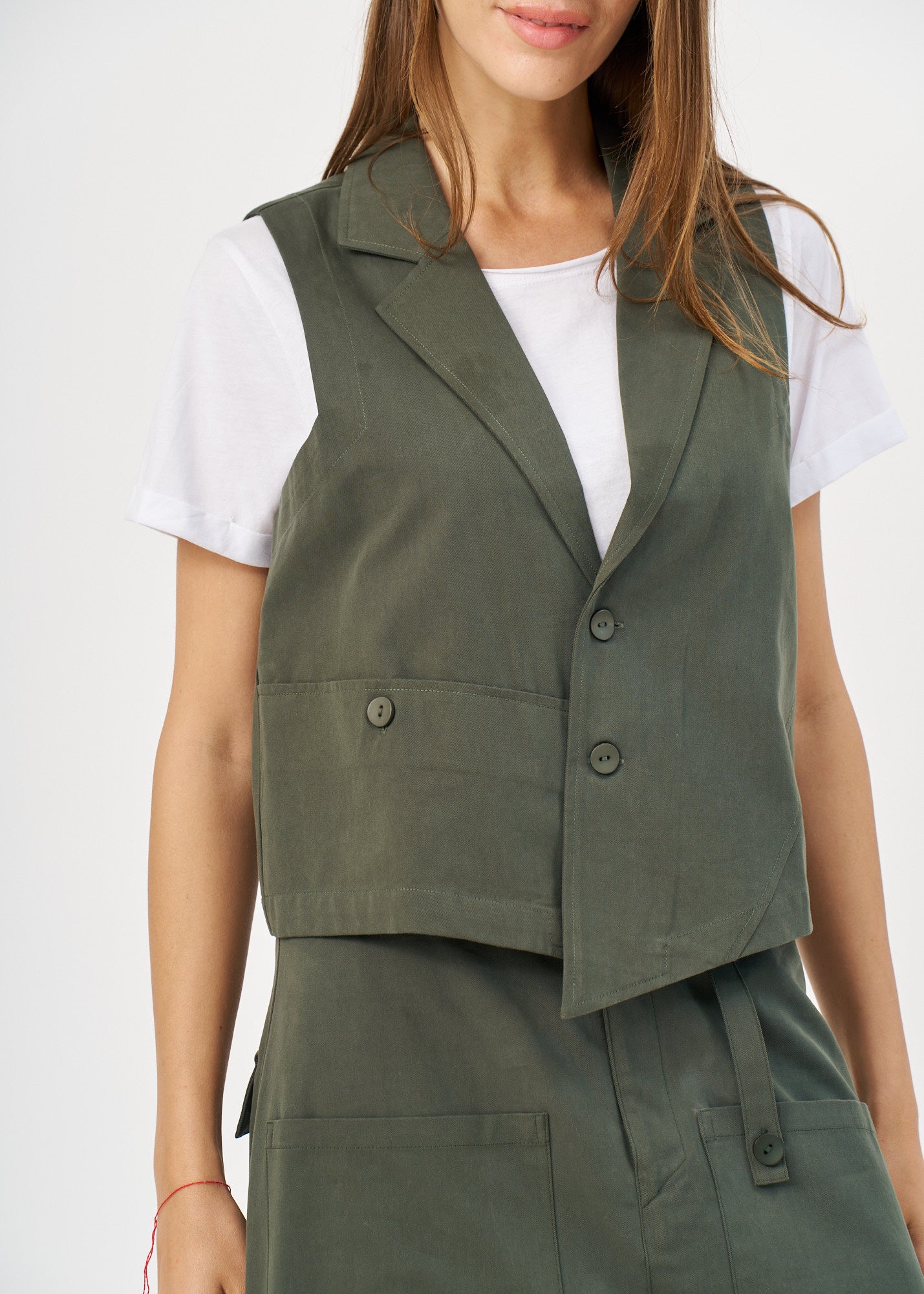Dark green asymmetrical extension vest