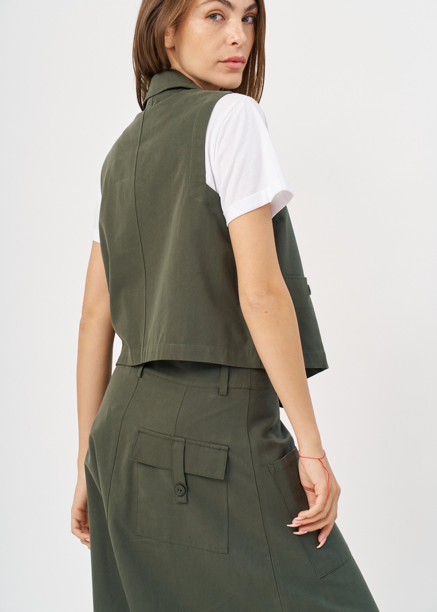 Dark green asymmetrical extension vest