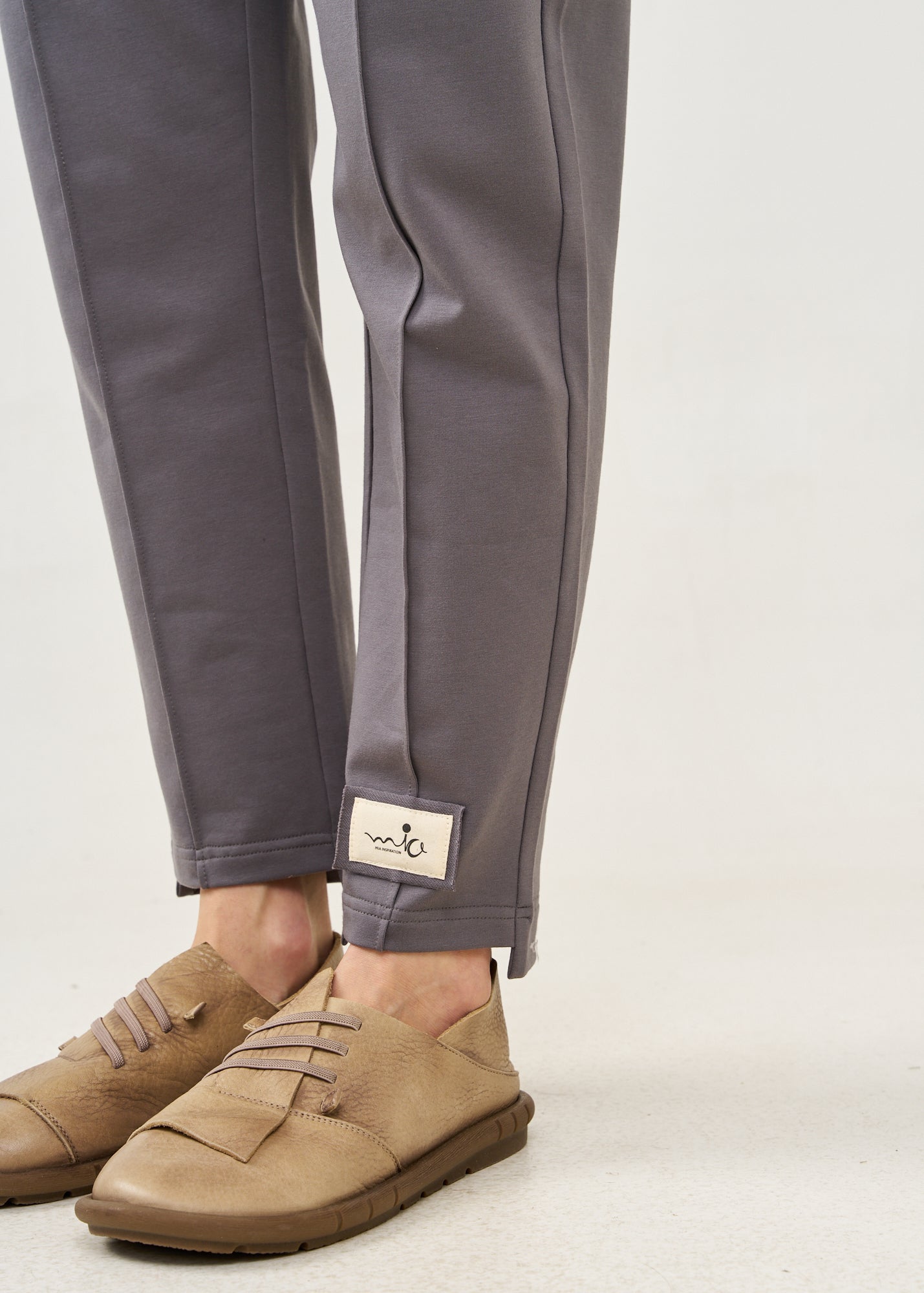 Pants with a seam in the middle and a dark gray patch