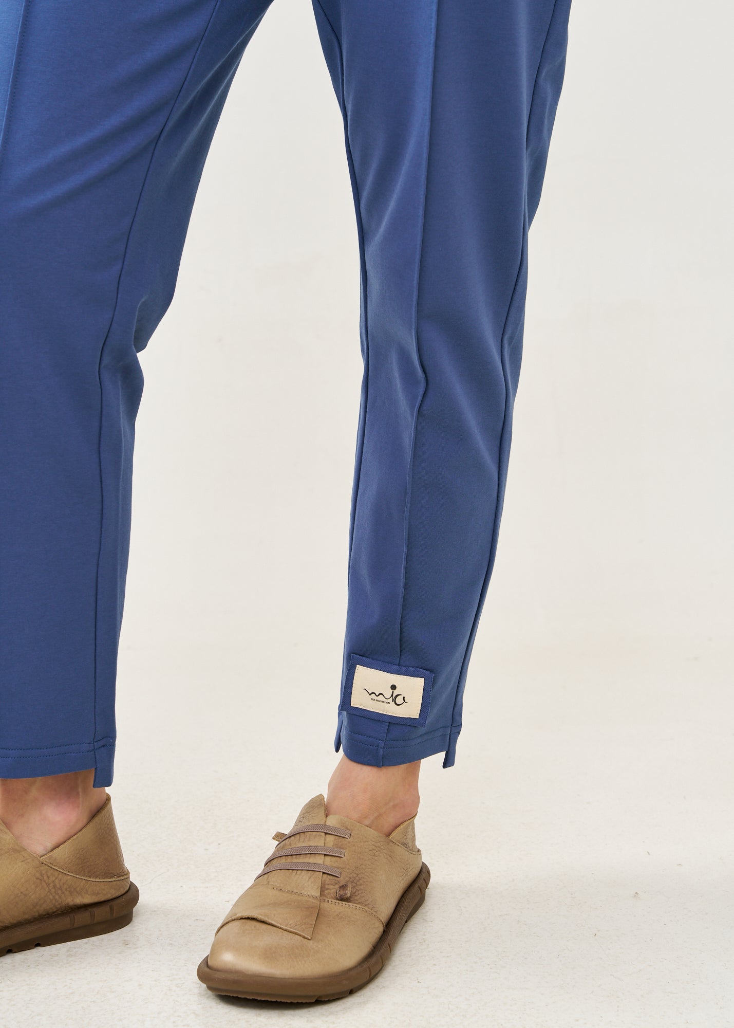Pants with a seam in the middle and a dark blue patch