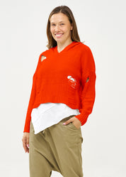 Knitwear with orange braid extension cap