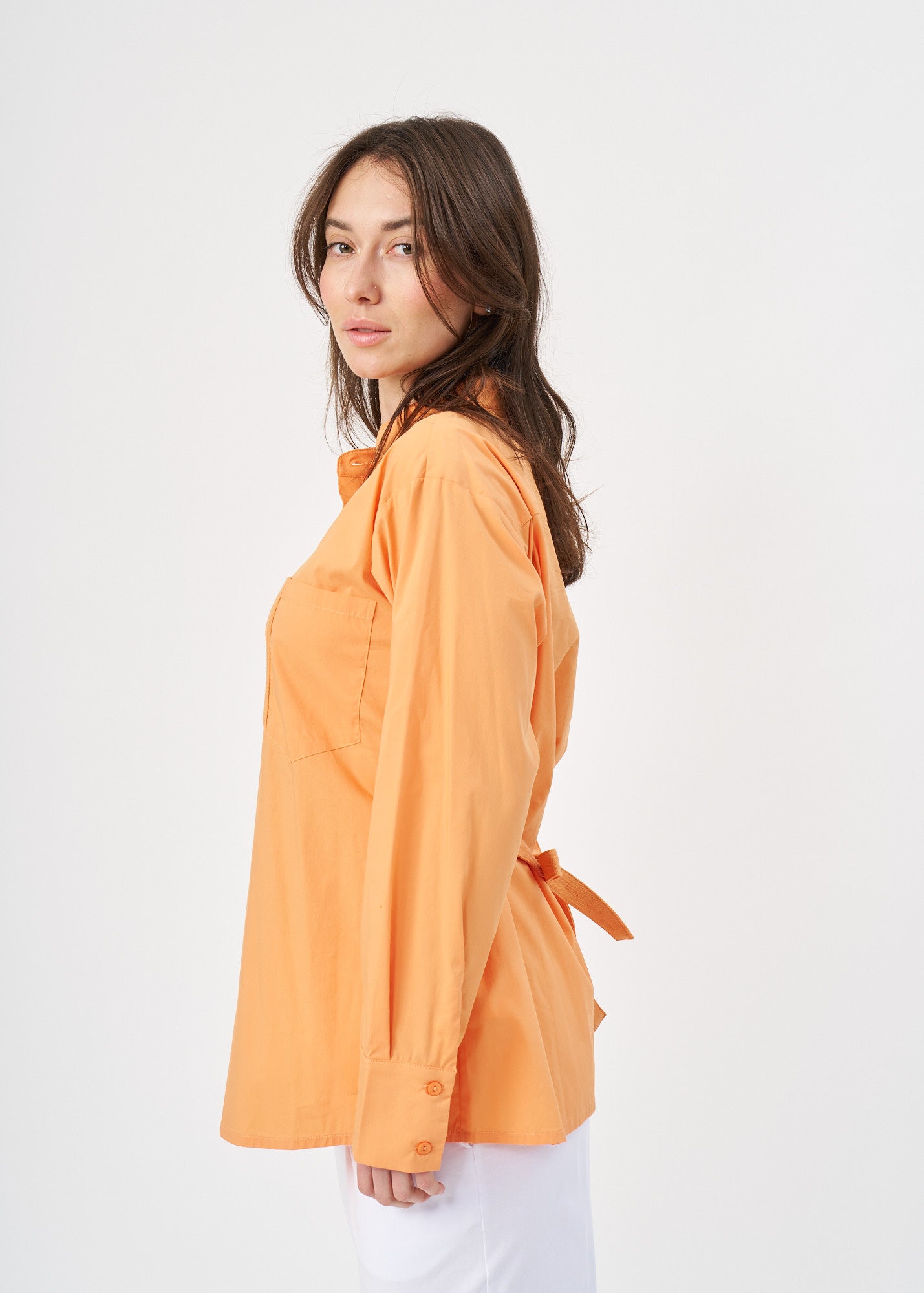 Orange button-down shirt with ribbon on the back