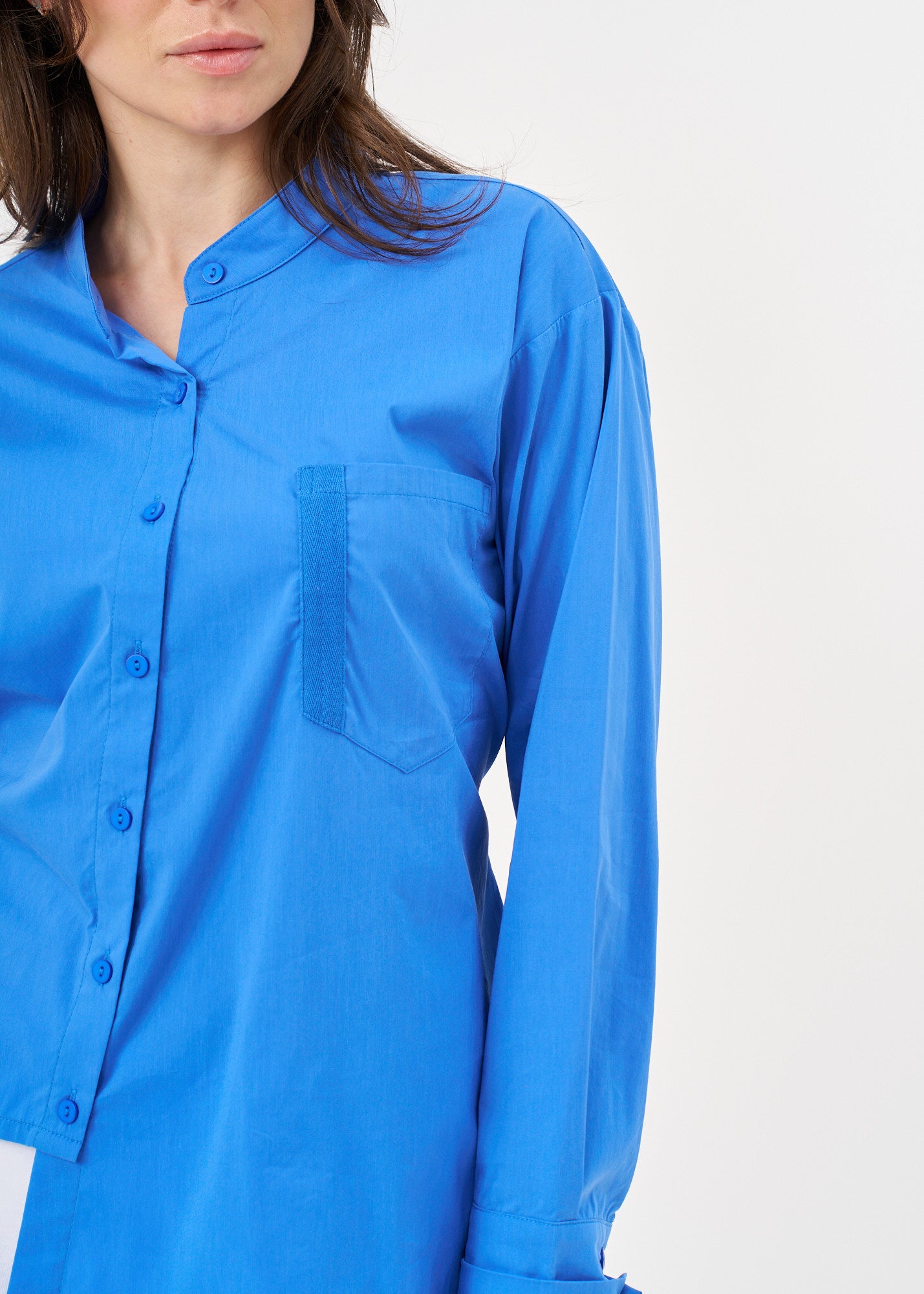 Blue button-down shirt with ribbon on the back