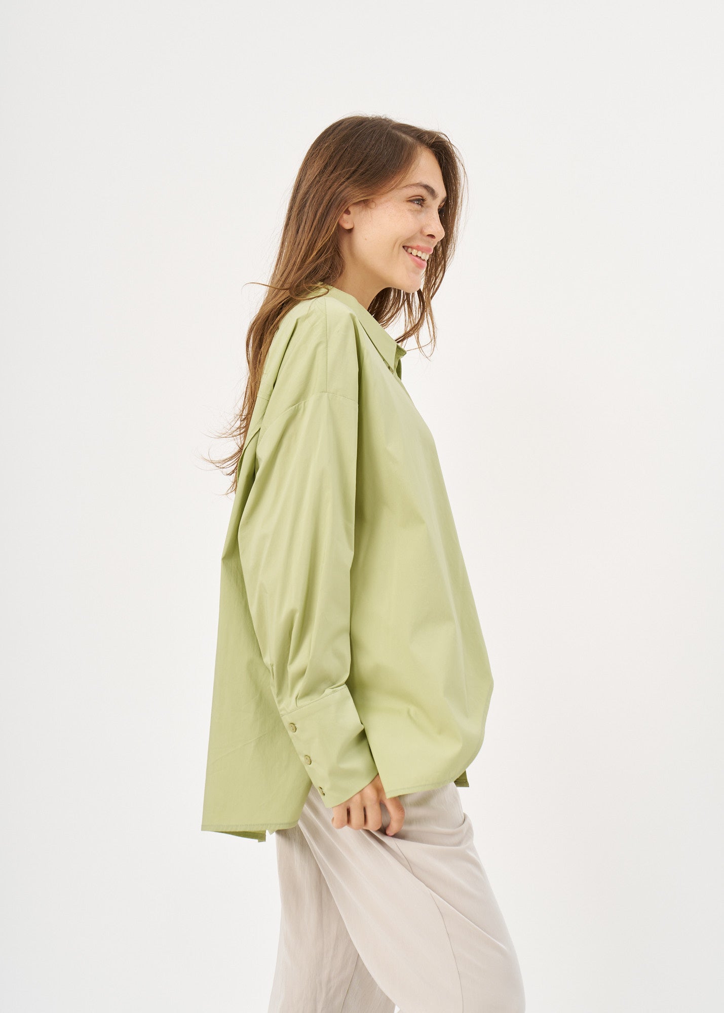 Green button-down shirt with diagonal hem and pocket