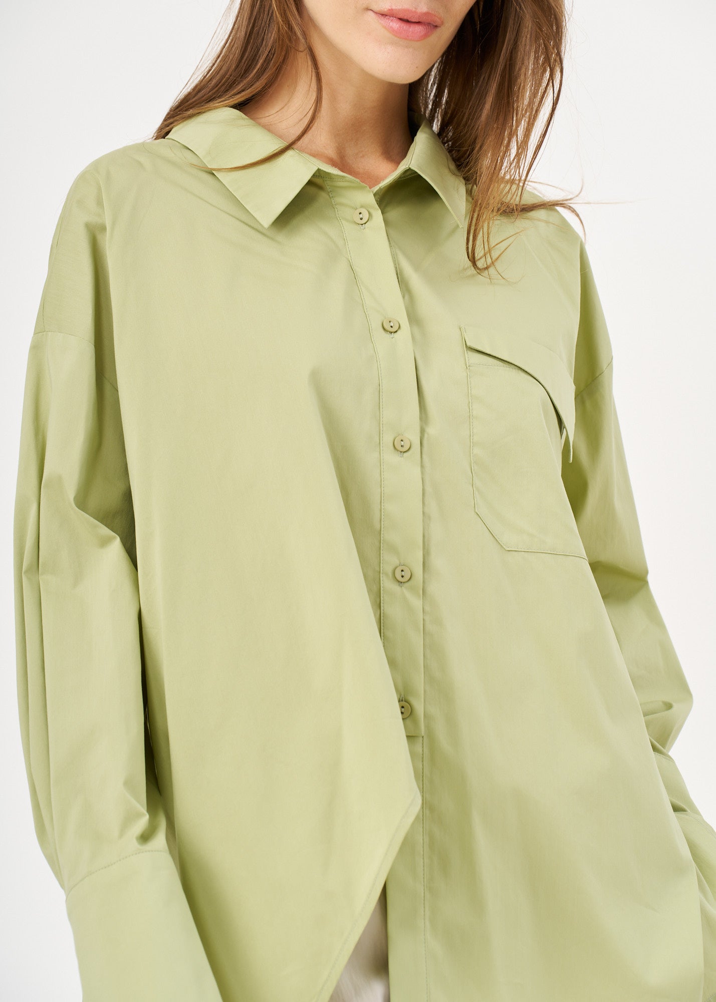 Green button-down shirt with diagonal hem and pocket