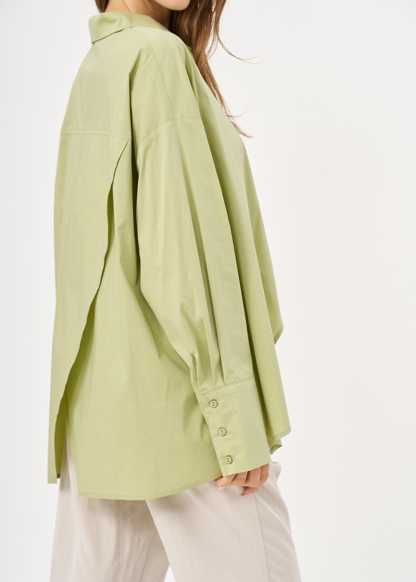 Green button-down shirt with diagonal hem and pocket