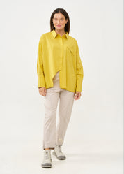 Button-down shirt with diagonal hem and mustard pocket