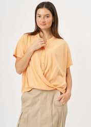 Shirt with buttons and a twisted orange extension