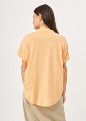 Shirt with buttons and a twisted orange extension
