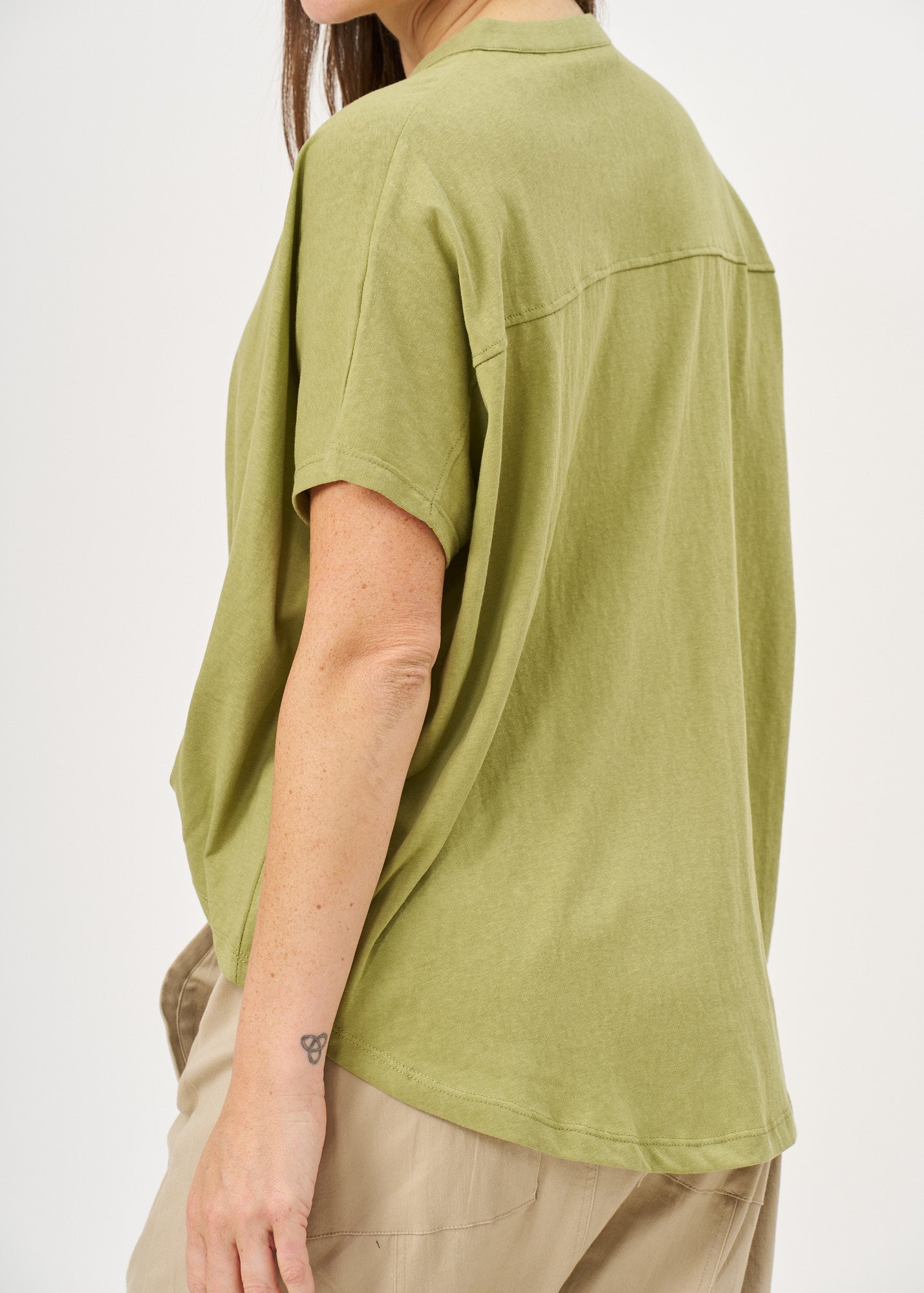 Green button-down shirt with a twisted hem
