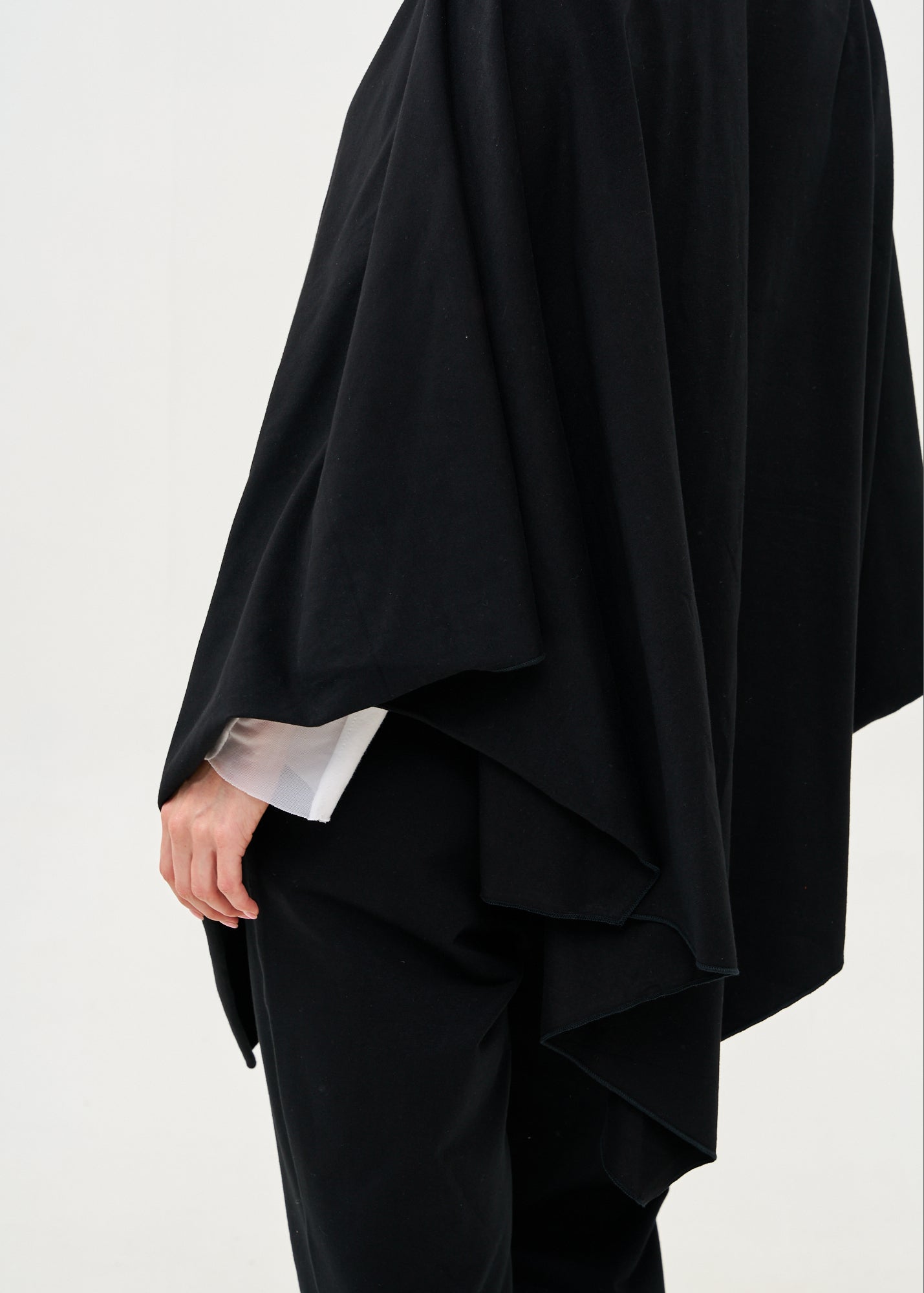 Black cape with diagonal closure