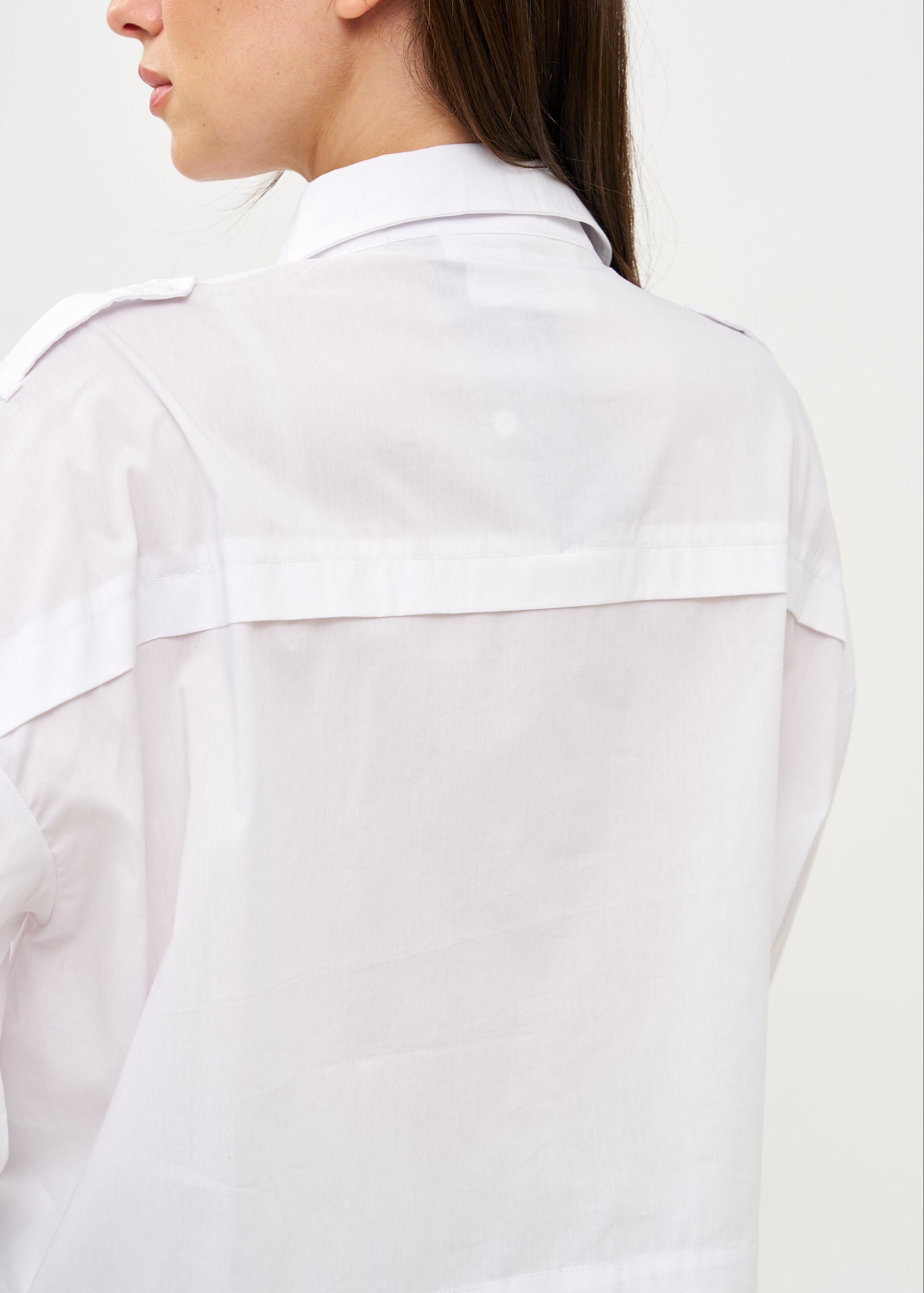 White button-down shirt with long shoulder straps