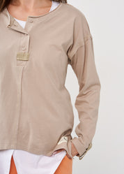 Long sleeve shirt with three buttons and brown ribbon