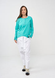 Long sleeve shirt with three buttons and turquoise ribbon