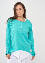 Long sleeve shirt with three buttons and turquoise ribbon