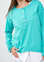 Long sleeve shirt with three buttons and turquoise ribbon