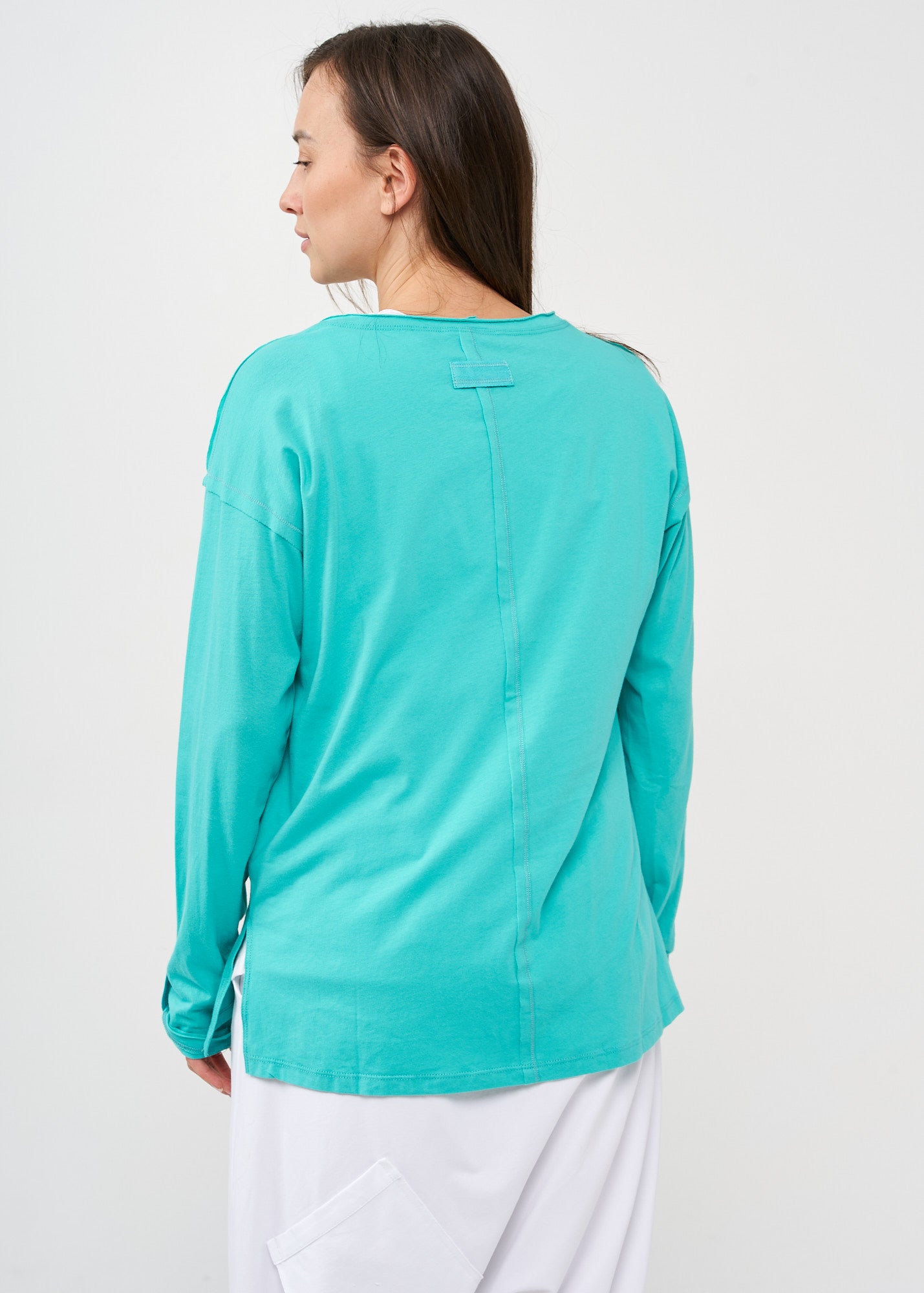 Long sleeve shirt with three buttons and turquoise ribbon