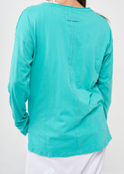 Long sleeve shirt with three buttons and turquoise ribbon