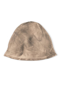 A sock hat rolls around in a beige wash - 99