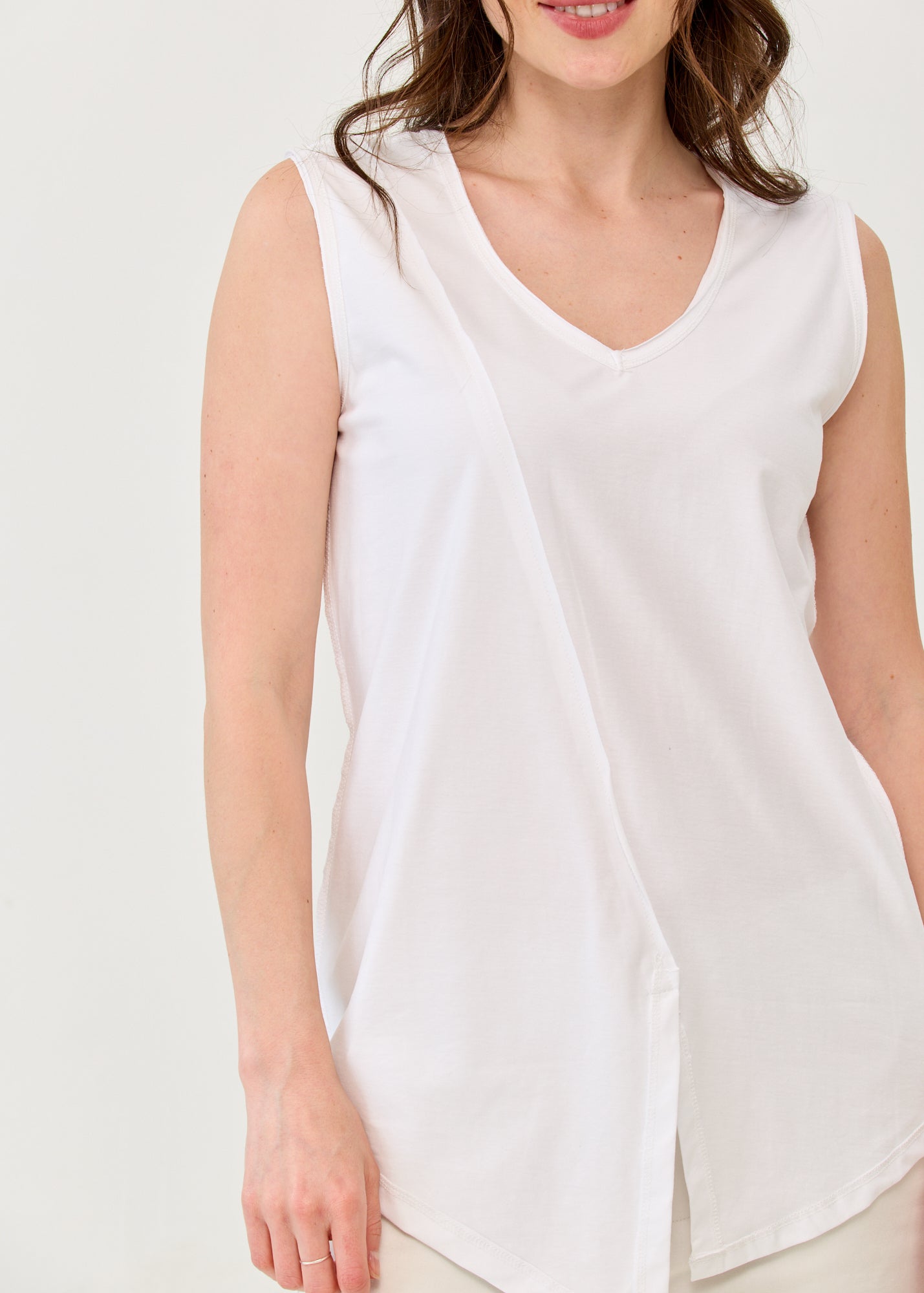 White V-neck tank top with diagonal stitching and slits