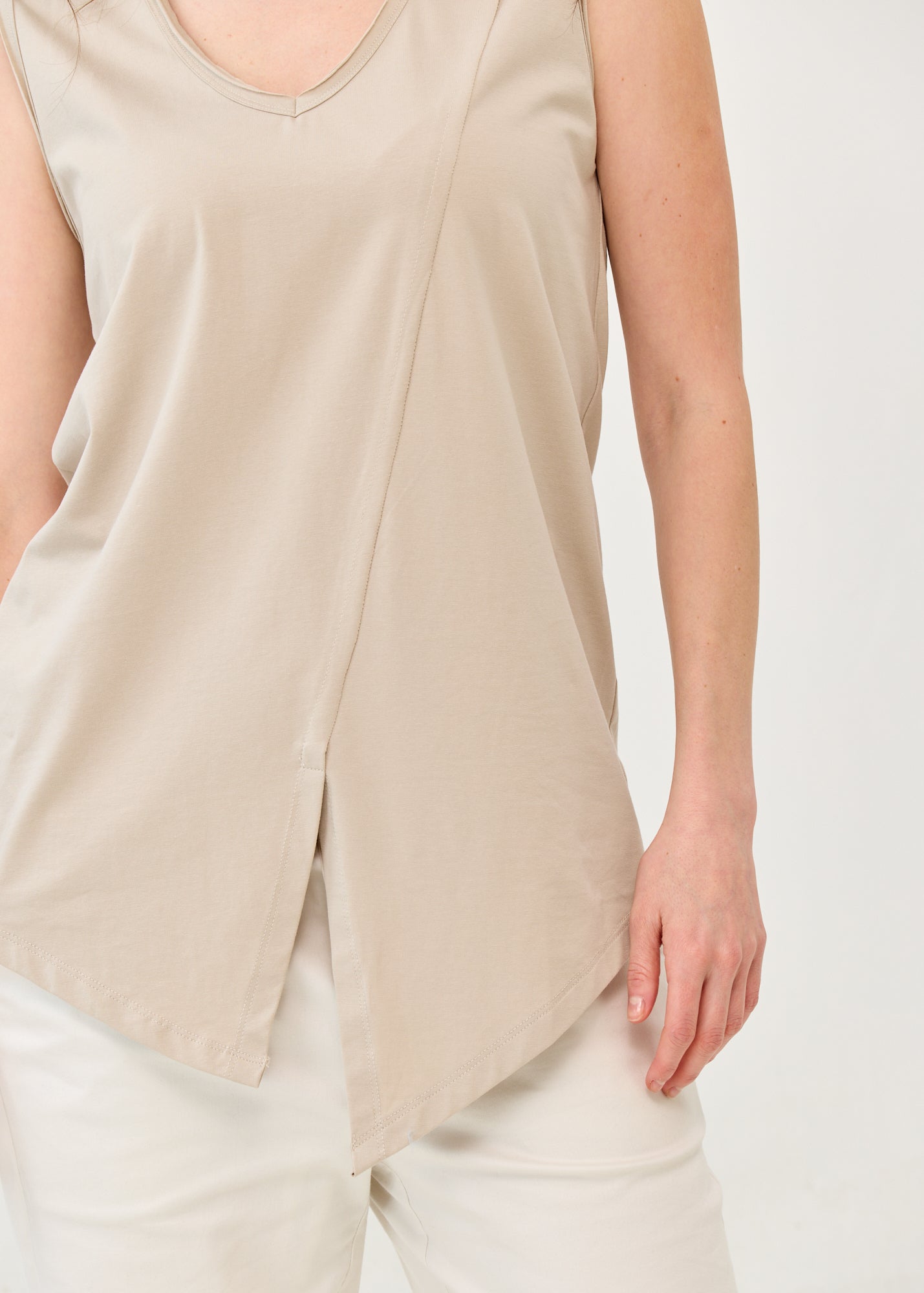 V-neck tank top with diagonal stitching and stone accents
