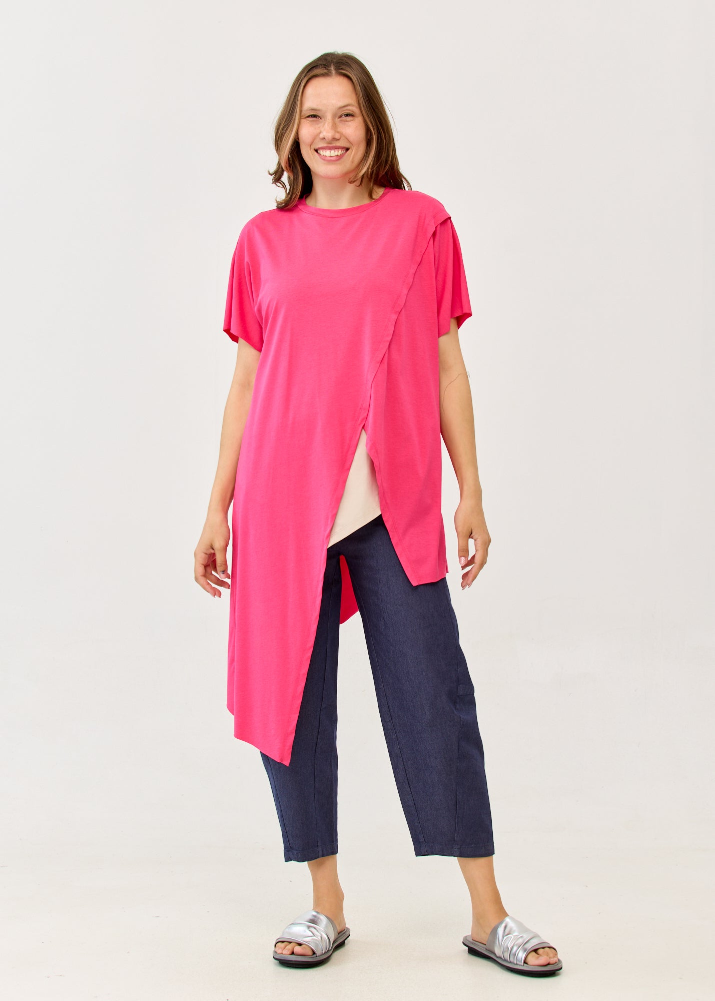Fuchsia pink short-sleeve tunic with an asymmetrical cut