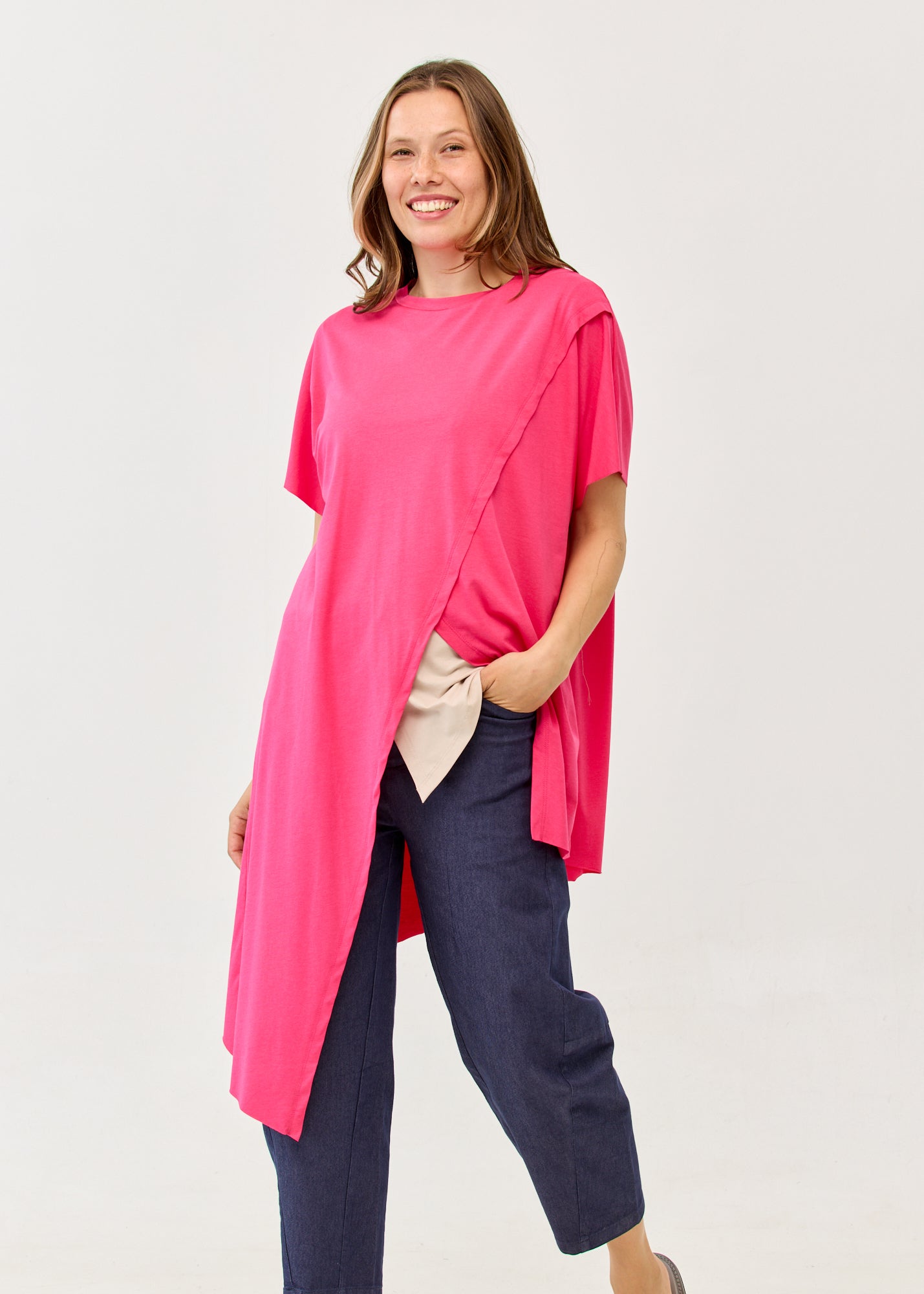 Fuchsia pink short-sleeve tunic with an asymmetrical cut