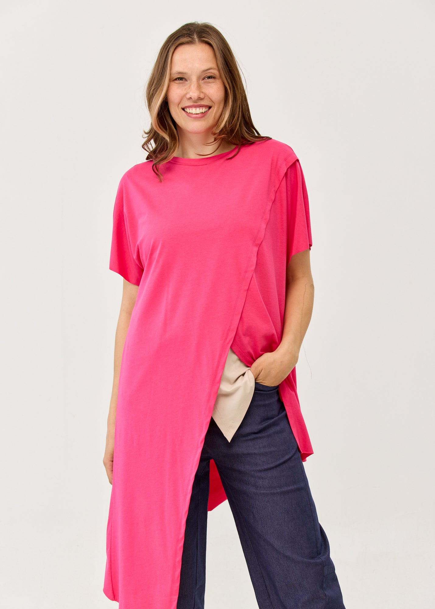 Fuchsia pink short-sleeve tunic with an asymmetrical cut