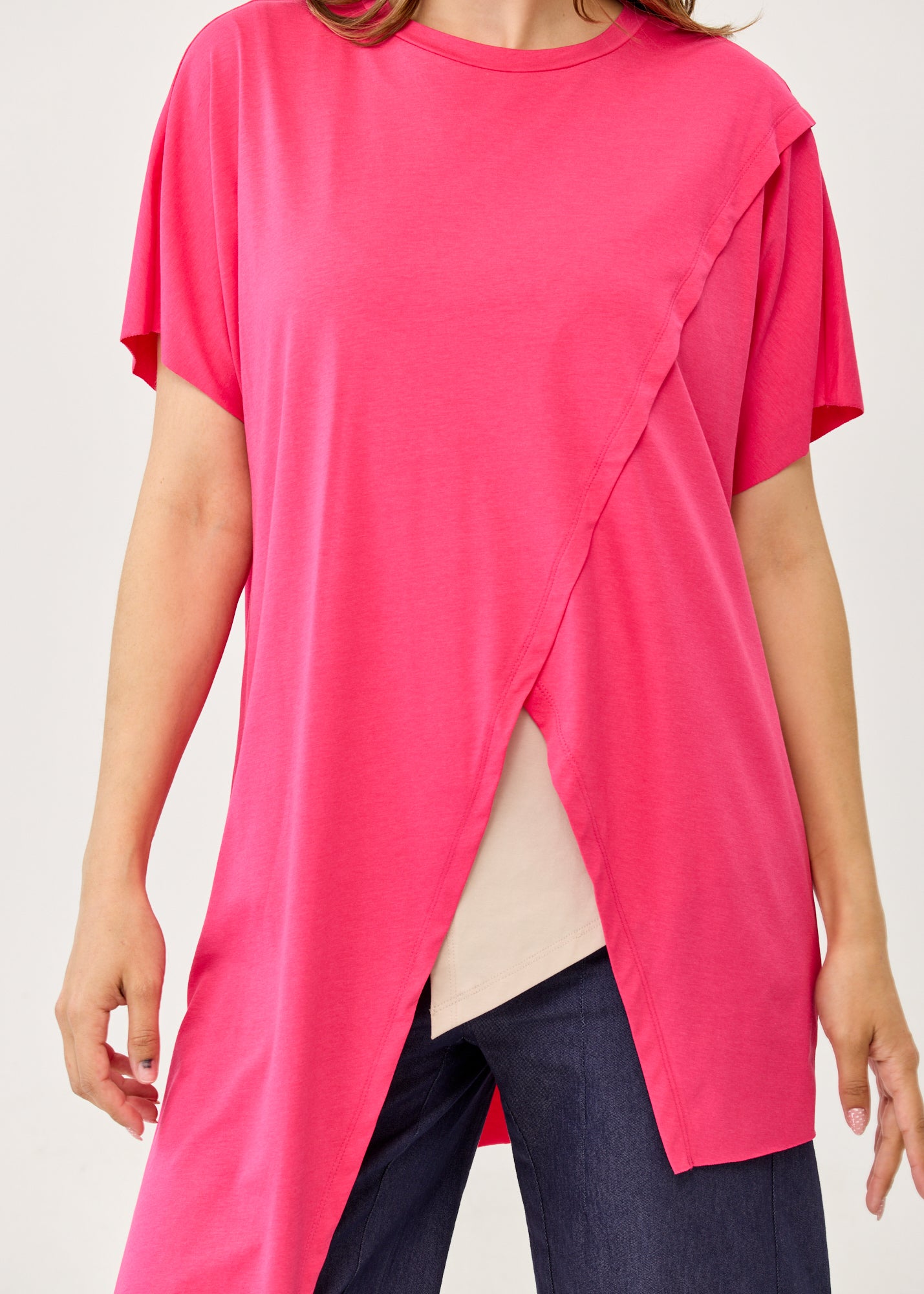 Fuchsia pink short-sleeve tunic with an asymmetrical cut