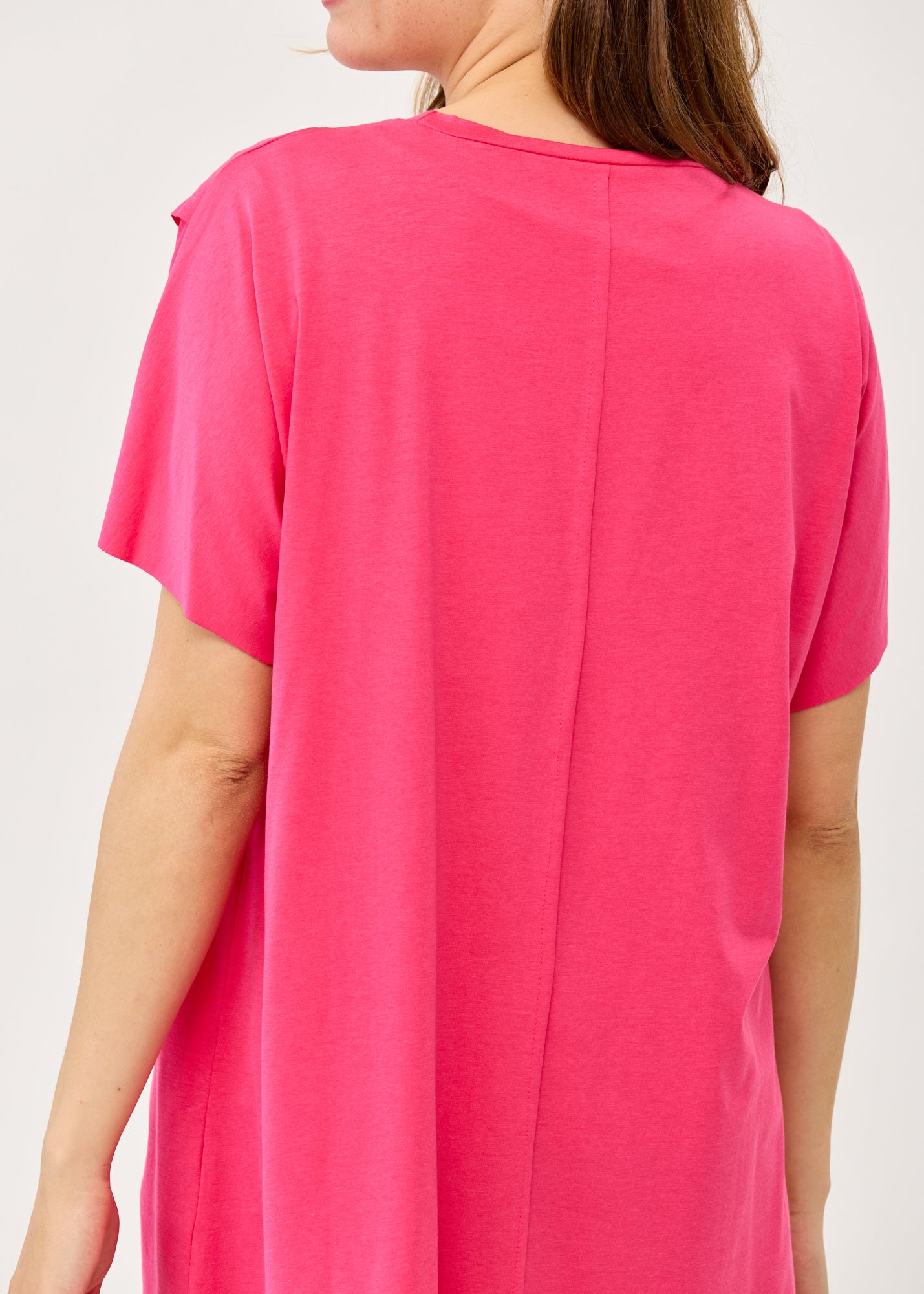 Fuchsia pink short-sleeve tunic with an asymmetrical cut