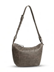 Leather evening bag with a thin strap and a dark brown ring