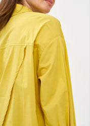 Button-down shirt with diagonal hem and mustard pocket