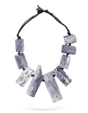 A chain of flaking wood attached to gray rectangular shapes