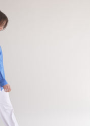 Blue button-down shirt with ribbon on the back